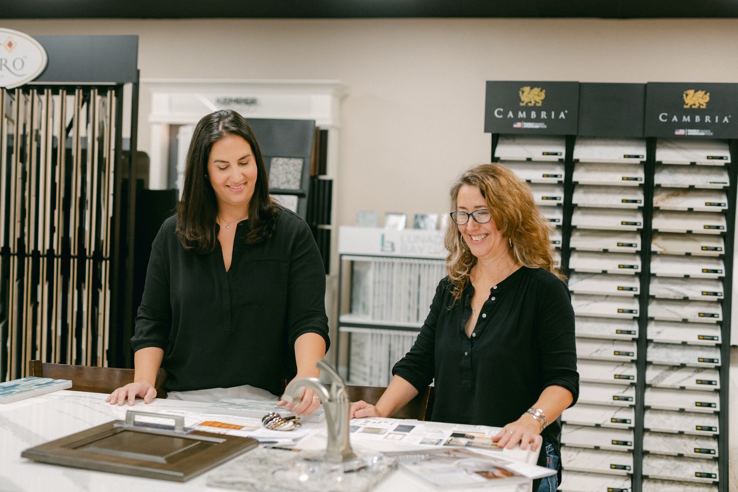 design team at Stewart Construction looking at samples and remodeling plans