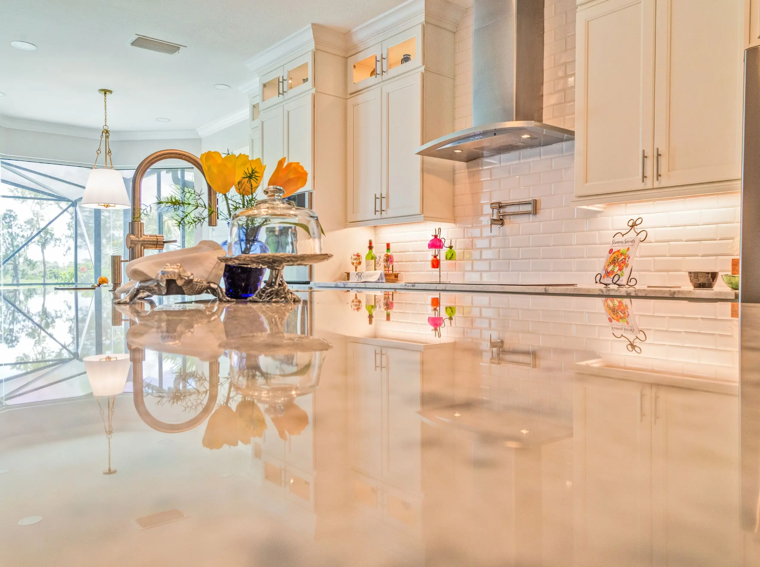 Remodeled kitchen in Sebring, FL with white cabinetry, wood accents, and modern lighting