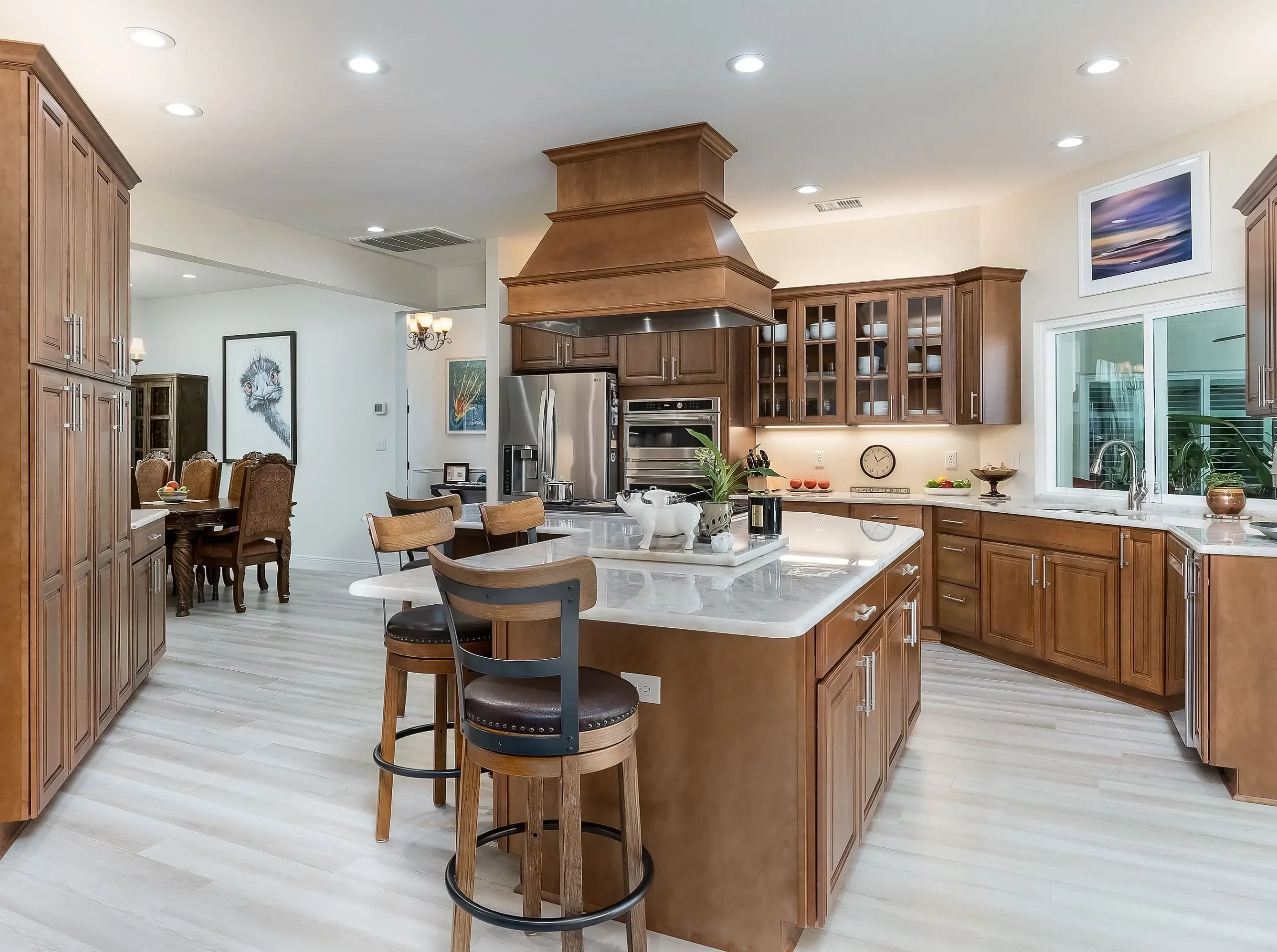 Traditional kitchen design with wood cabinetry and white countertops in Highlands County