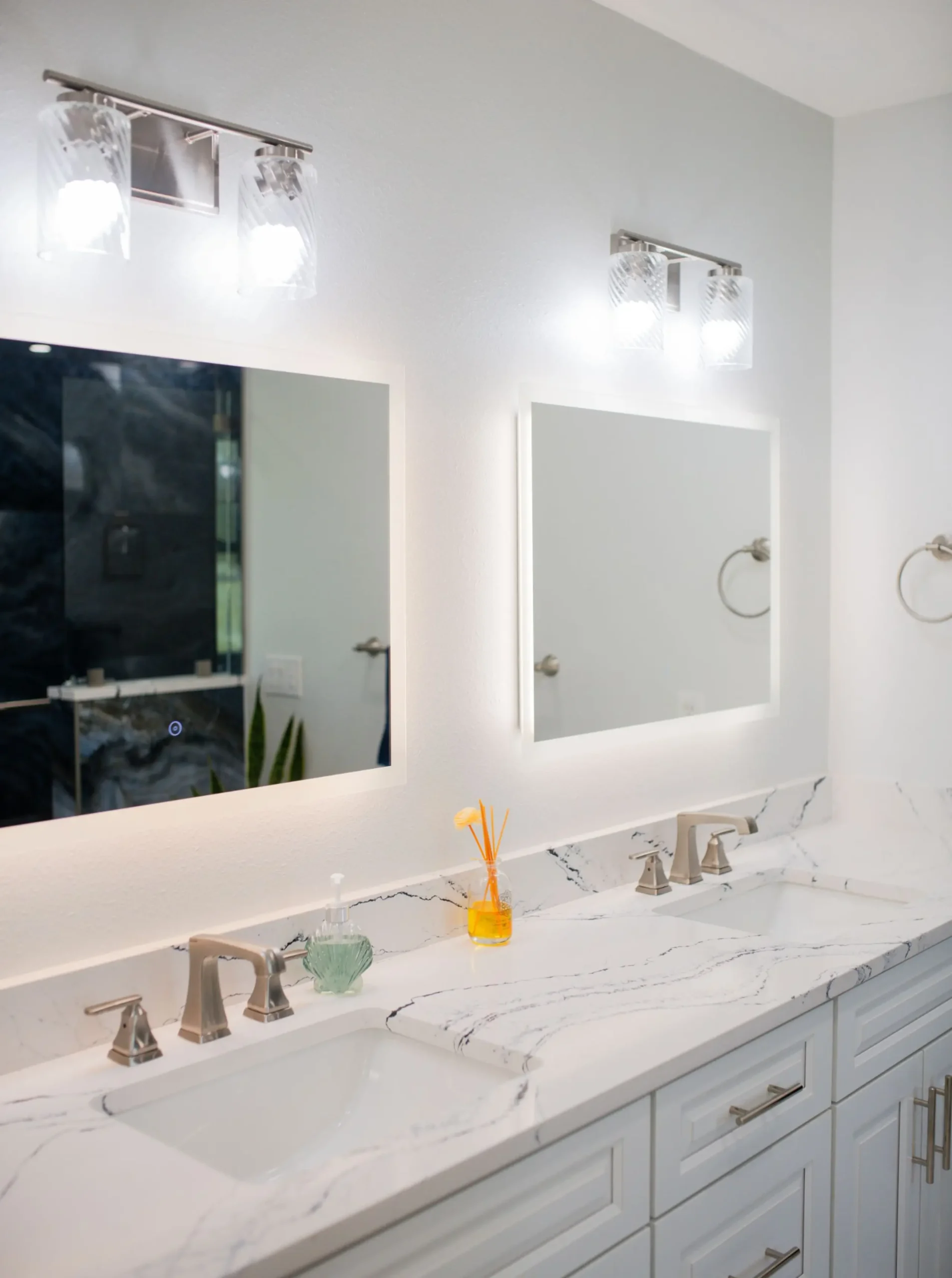 white vanity with double sink, frameless mirror