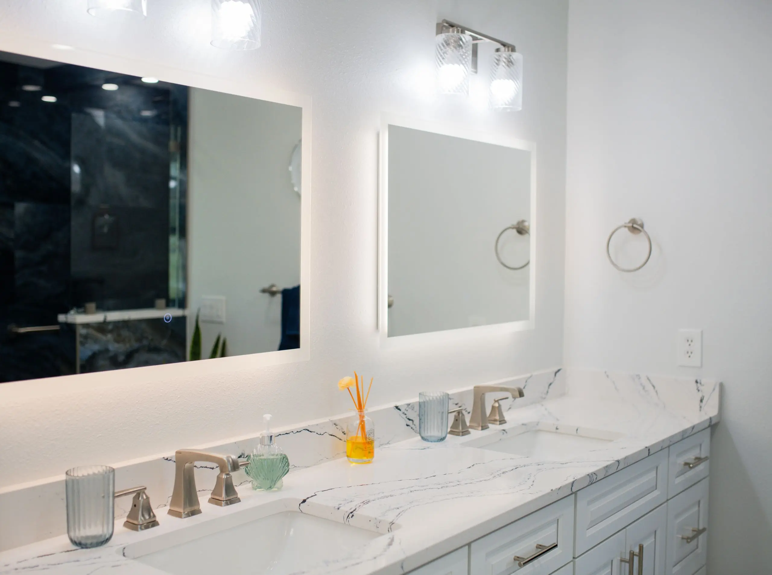 white vanity with double sink in a primary bathroom remodel