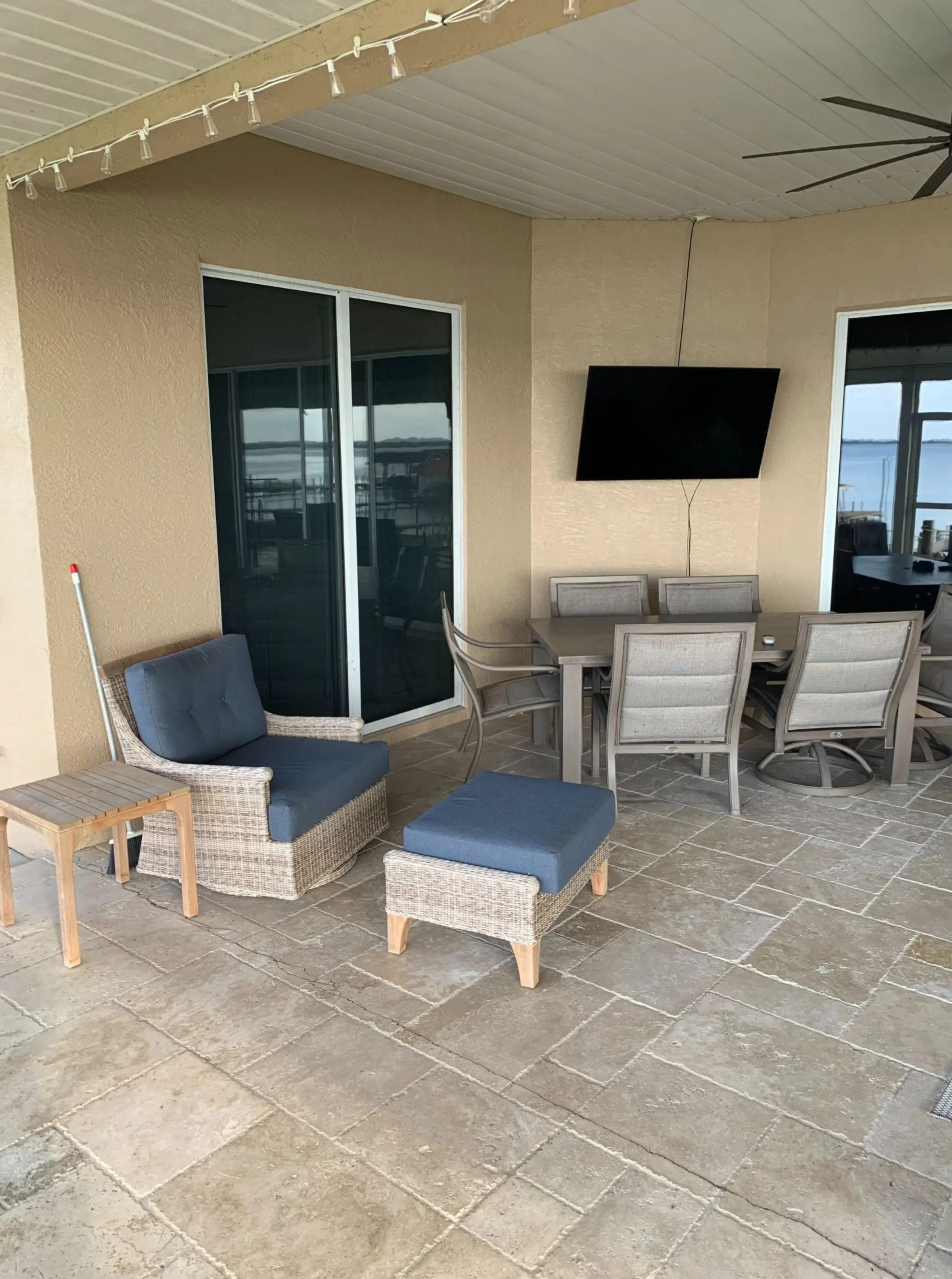 an old outdated patio with dining room table and chair