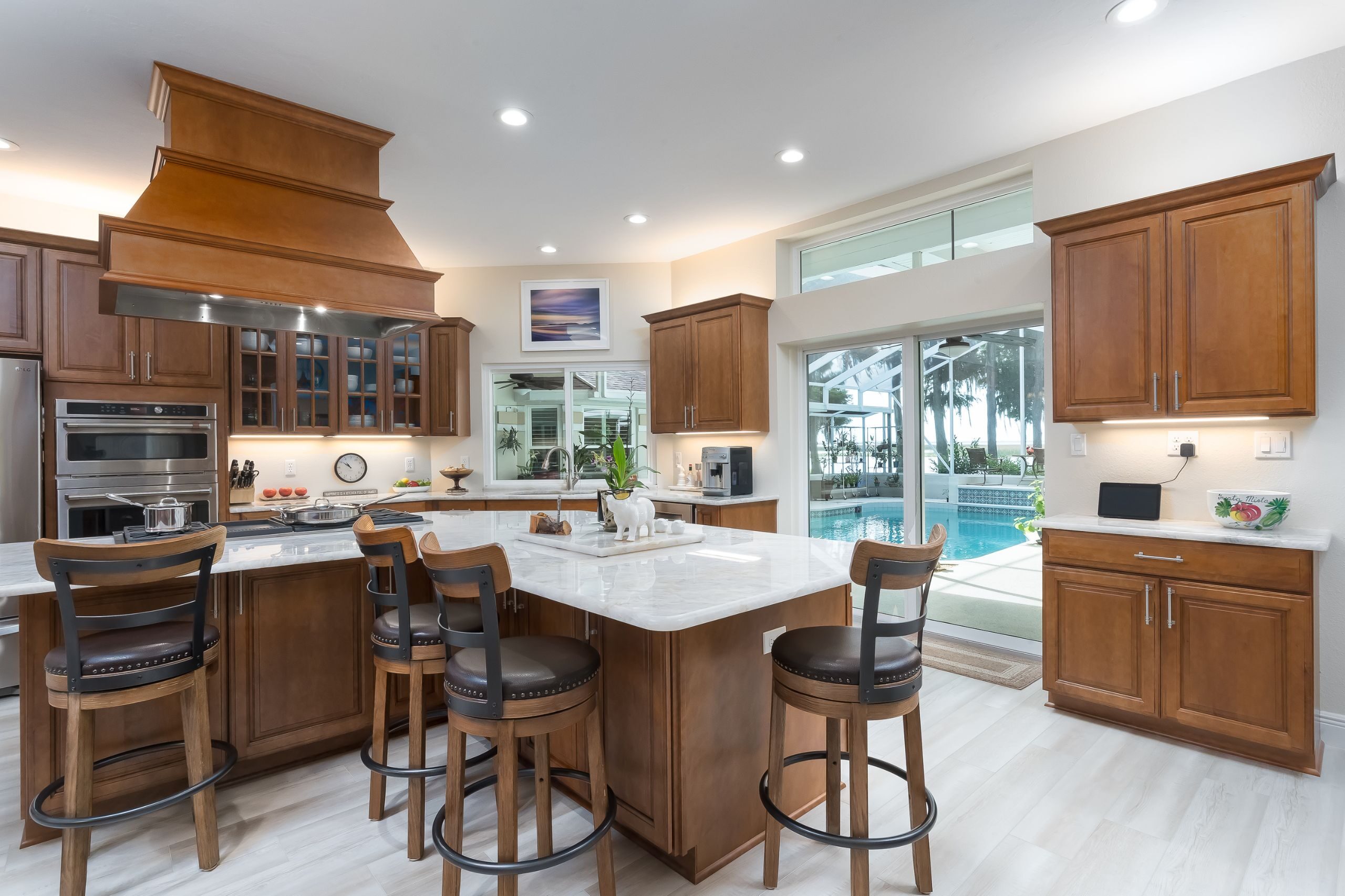 traditional style wood kitchen with patio doors leading to a pool room in Highlands County, FL