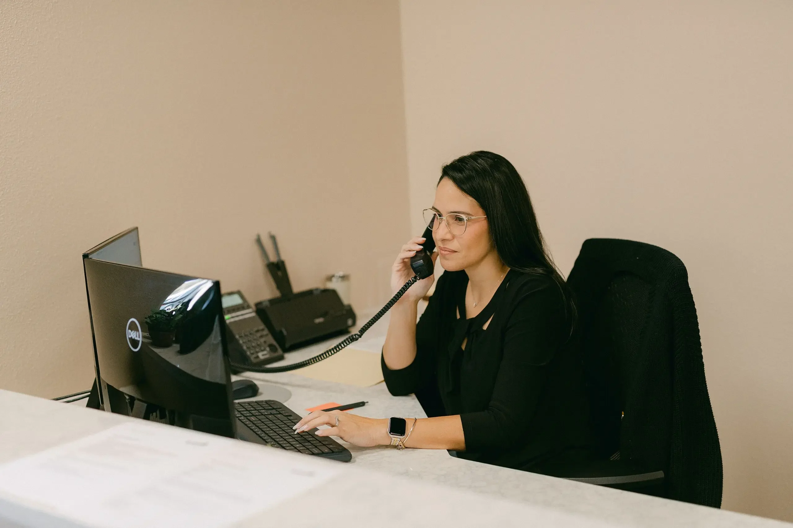 office staff communicating with a customer on the phone
