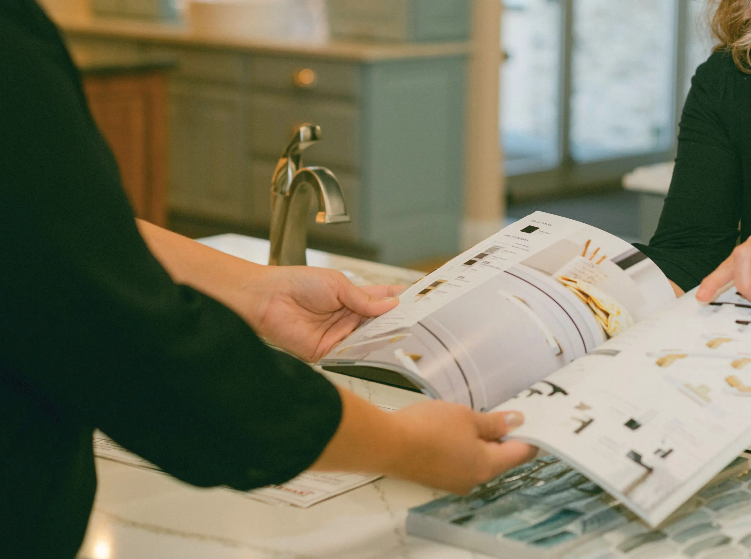 designers explaining remodeling costs to homeowner in sebring, fl remodeling showroom