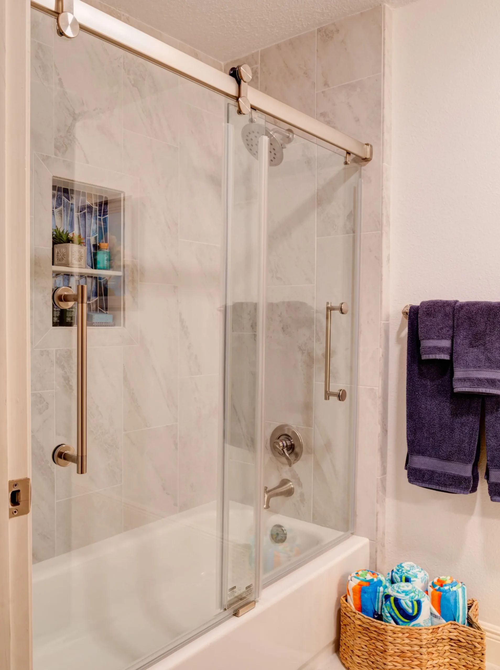 Bathroom featuring tub and glass shower