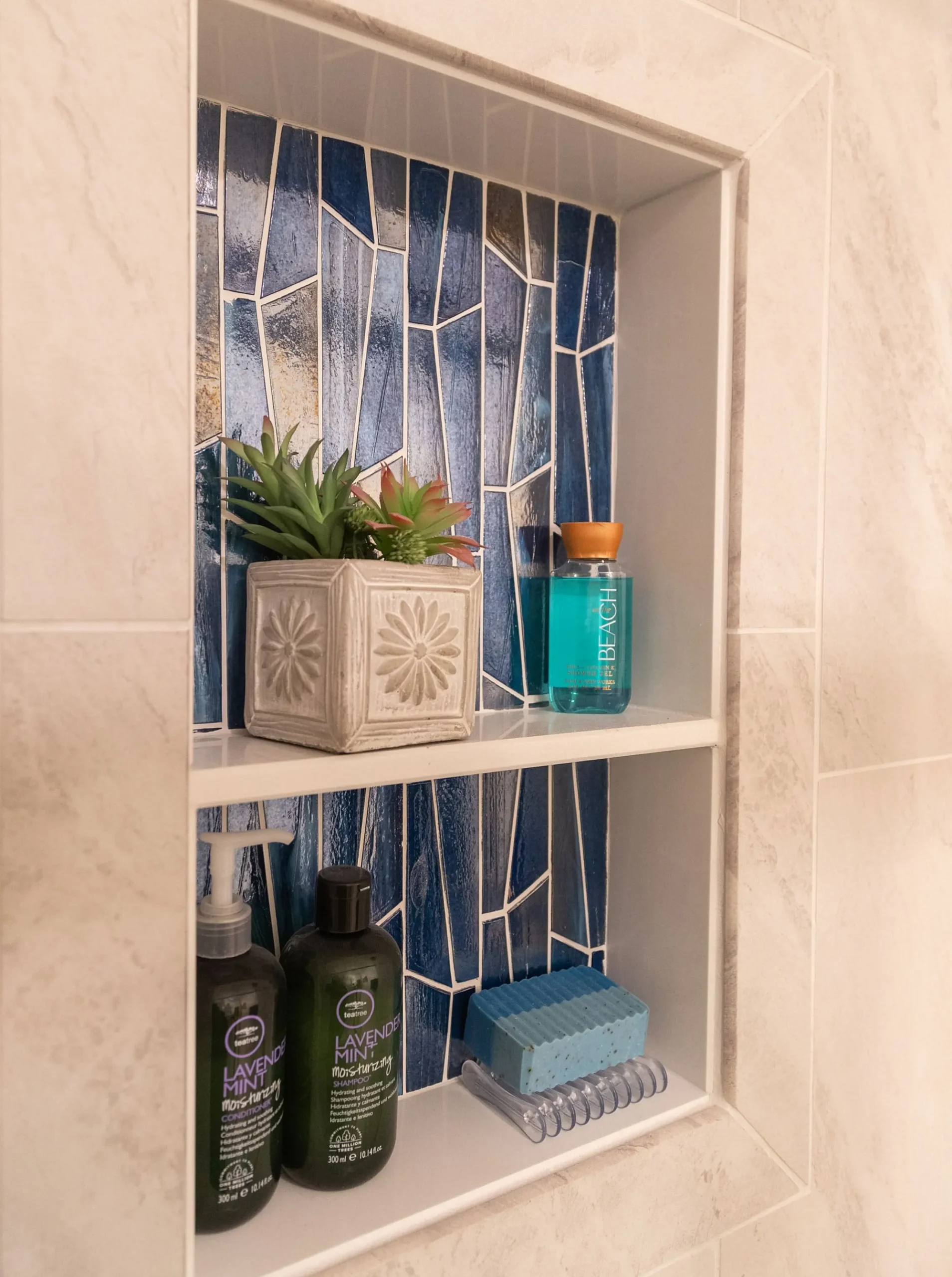Shower niche featuring bold decorative accent tile