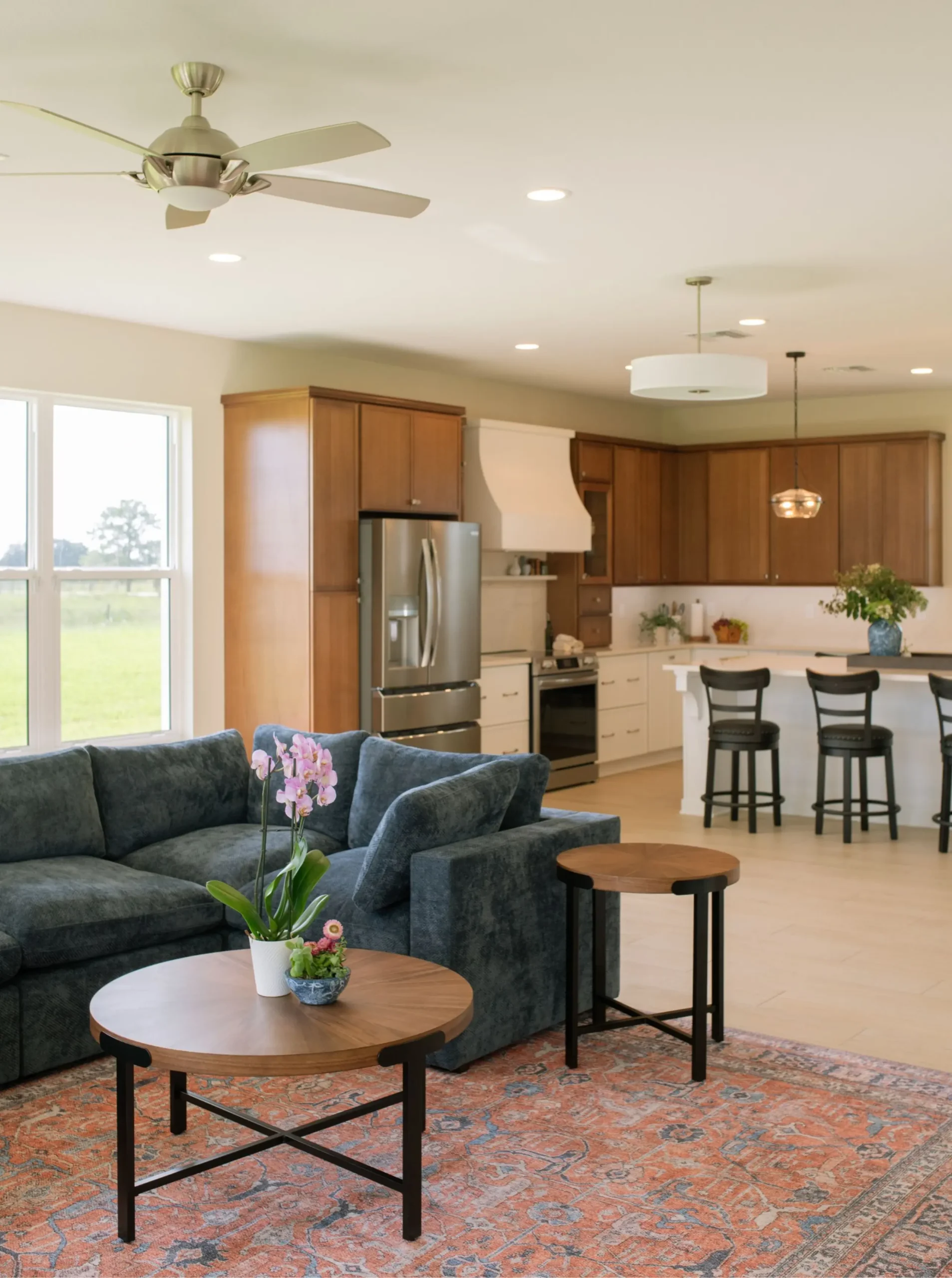 Open-concept kitchen connecting to the dining and living areas of a Sebring custom home