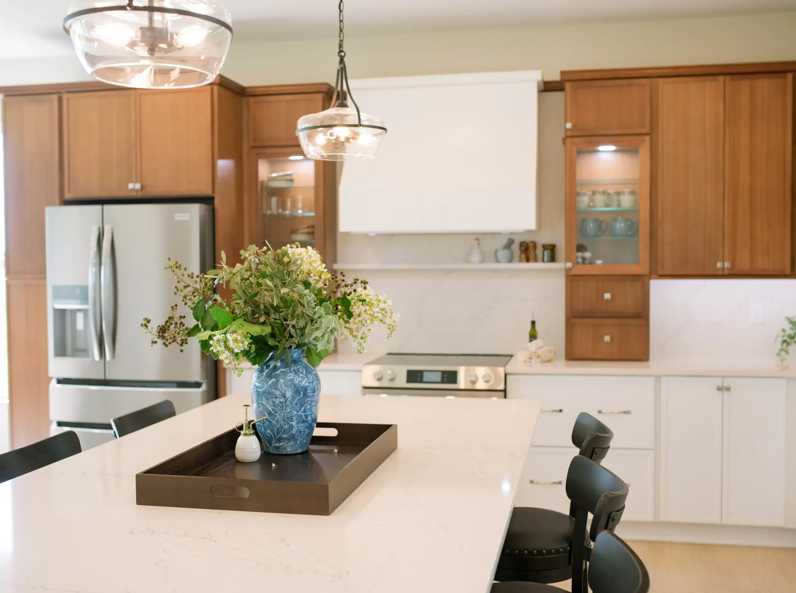 Custom kitchen island with seating at both ends and white countertops