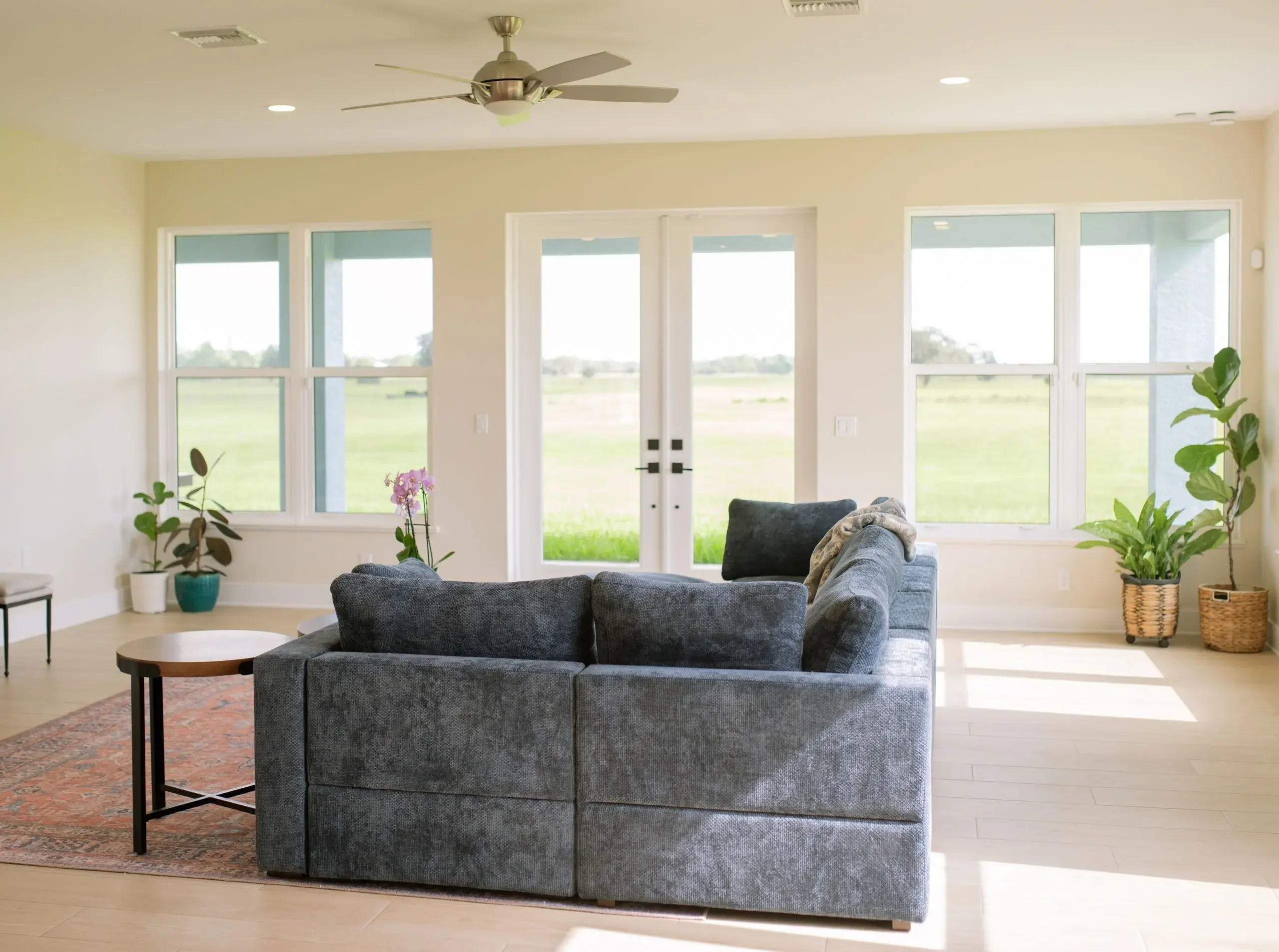 Bright living room with large windows and French doors overlooking the surrounding property in Sebring, FL